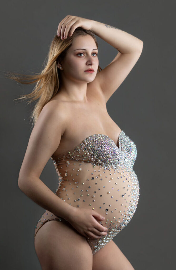Studio maternity photography of pregnant woman in crystal embellished bodysuit with modern editorial styling