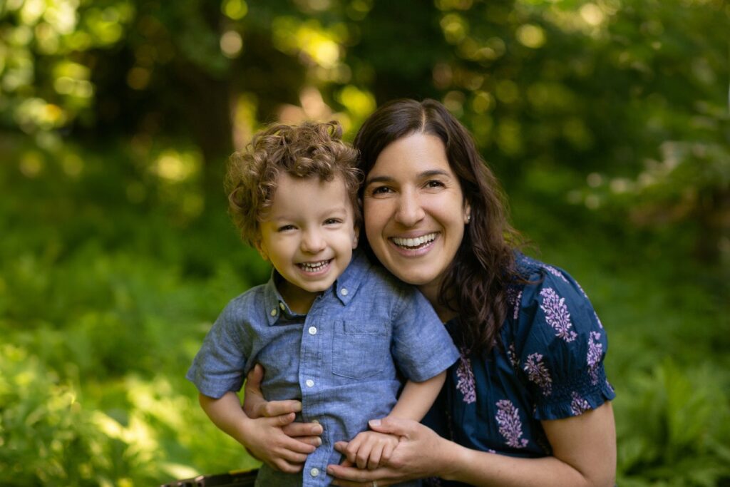 Mother and young son smiling together during an outdoor Baby Plan portrait session