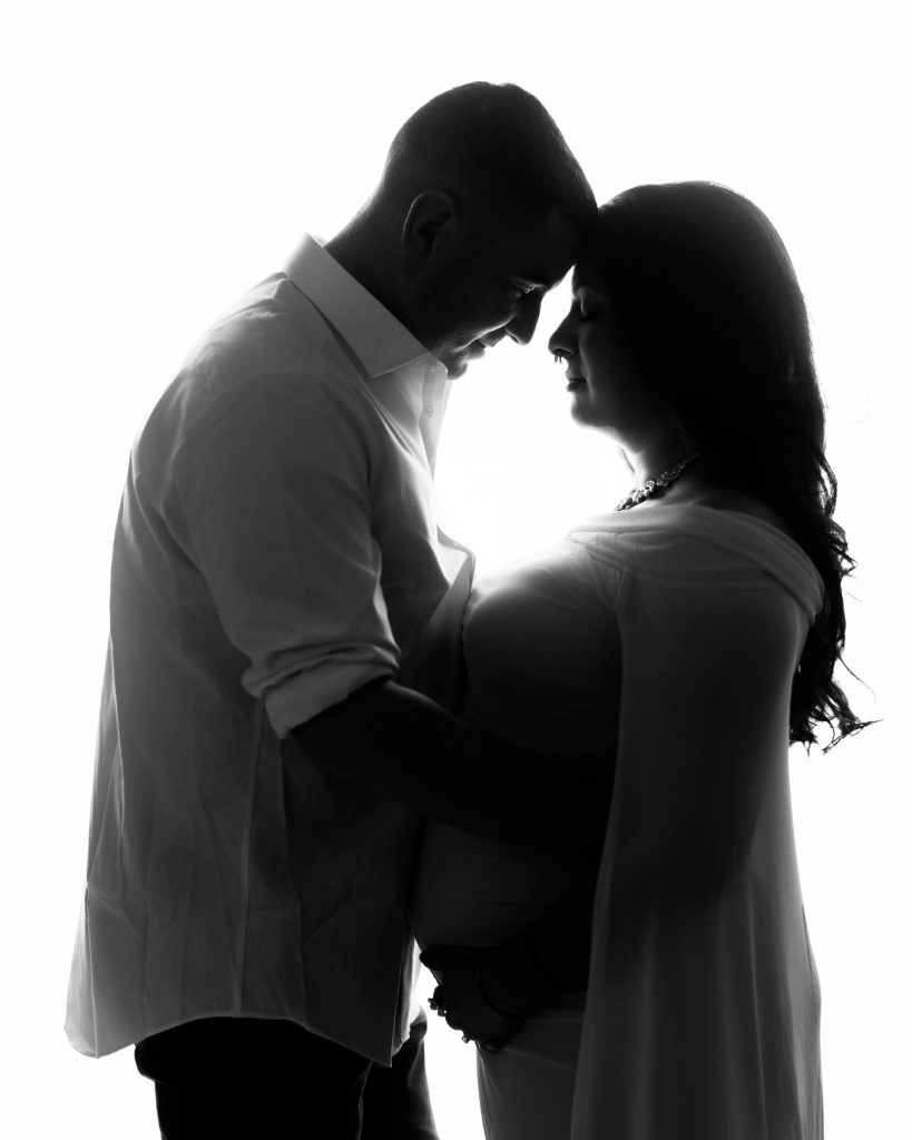 Close silhouette portrait of an expecting couple during a Boston maternity session.